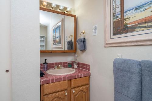 a bathroom with a sink and a mirror at River Love, private dock Moovalya Keys in Parker
