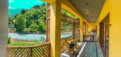 a balcony with a view of a river and mountains at Bono Riverside Apartments in Nārān