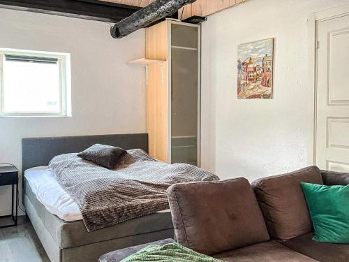 a living room with a bed and a couch at 4 person holiday home in ANDERSLÖV in Anderslöv