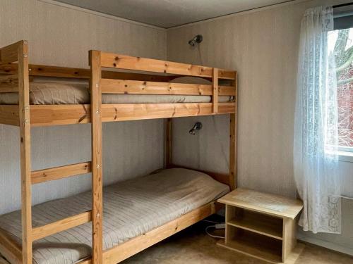 two bunk beds in a room with a window at 4 person holiday home in KÖPINGSVIK in Köpingsvik