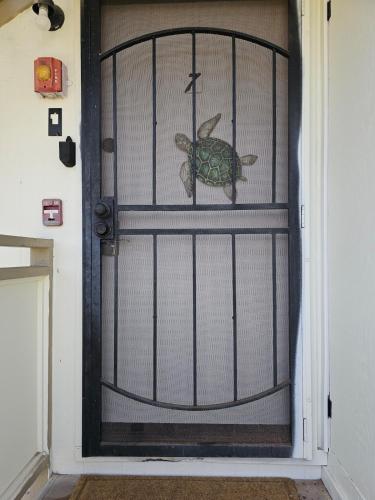 a door with a turtle painted on it at Comfort Location Reasonable Price 2 blocks 2 the beach in Kailua-Kona