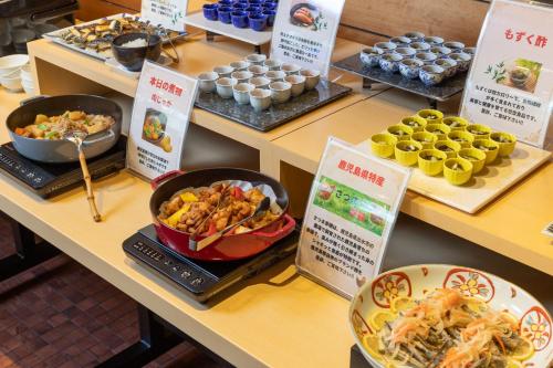a buffet with different types of food on display at Hotel Sundays Amami in Amami