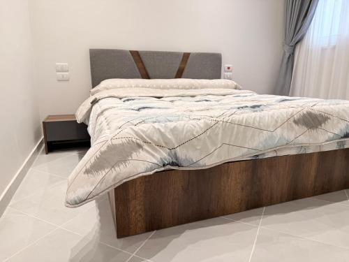 a bedroom with a bed with a wooden frame at Bohemia palace in Hurghada