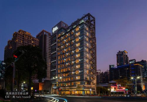 a tall building on a city street at night at 采寓halo house in Taichung