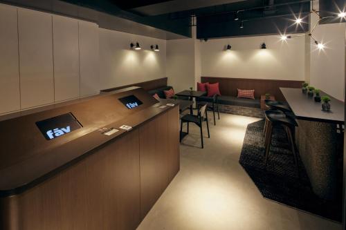 a restaurant with a bar with tables and chairs at fav TAKAMATSU in Takamatsu