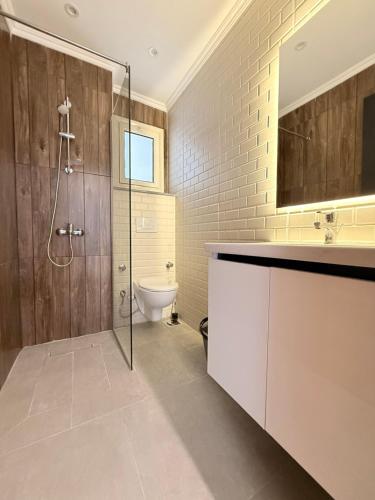 a bathroom with a shower and a sink and a toilet at Bohemia palace in Hurghada