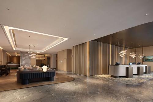 a lobby of a hotel with a reception desk at Hilton Garden Inn Harbin Haxi in Harbin