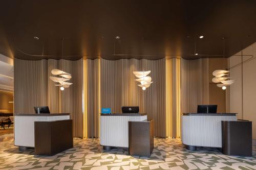 a lobby with two desks with laptops on them at Hilton Garden Inn Harbin Haxi in Harbin