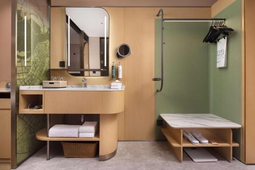 a bathroom with a sink and a shower at Hilton Garden Inn Harbin Haxi in Harbin