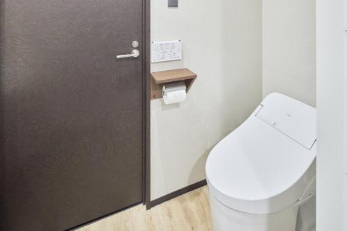 a bathroom with a toilet and a door at fav TAKAMATSU in Takamatsu
