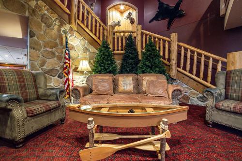a living room with a couch and two chairs at The Lodge at Brainerd Lakes, Trademark Collection by Wyndham in Baxter
