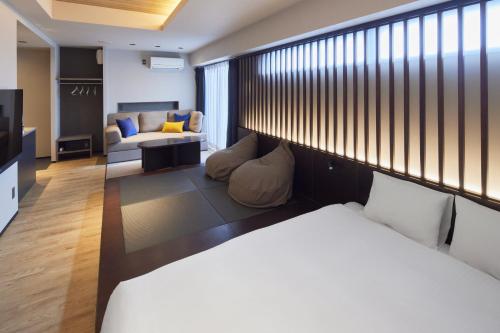 a hotel room with a bed and a couch at fav TAKAMATSU in Takamatsu