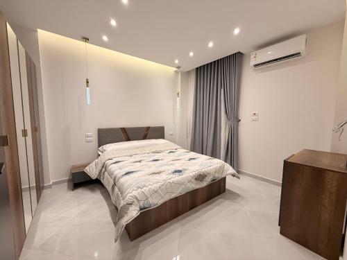 a bedroom with a bed in a white room at Bohemia palace in Hurghada