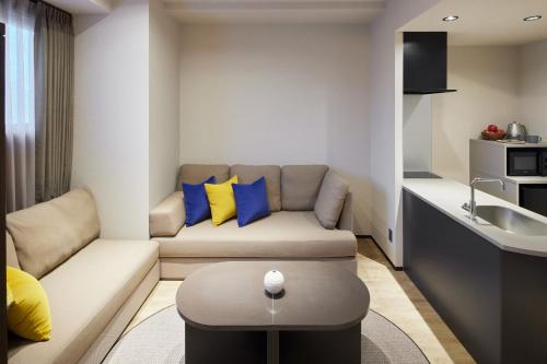 a living room with a couch and a sink at fav TAKAMATSU in Takamatsu