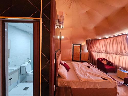 a small room with a bed and a bathroom at Wadi Rum star in Wadi Rum