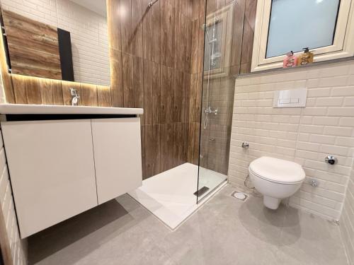 a bathroom with a toilet and a glass shower at Bohemia palace in Hurghada