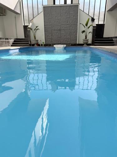 a swimming pool with blue water in a building at Bohemia palace in Hurghada