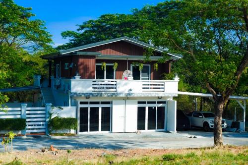 a house with a dog sitting on the balcony at The Twin Hanger Cabin A in Hermosa