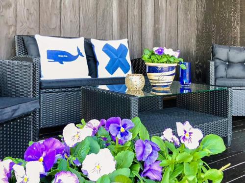 a patio with chairs and a table with flowers at 7 person holiday home in Molde in Molde