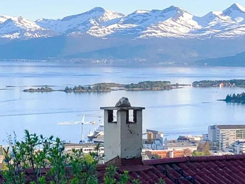 a view of a city and a lake with snow covered mountains at 7 person holiday home in Molde in Molde