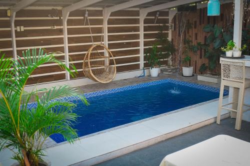 a swimming pool in the middle of a patio with plants at The Twin Hanger Cabin A in Hermosa