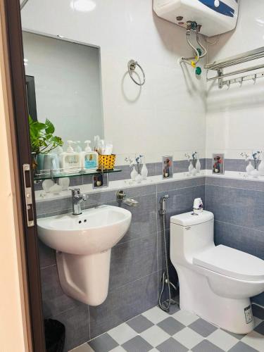 a bathroom with a sink and a toilet and a mirror at Alu Homestay SaPa in Sapa