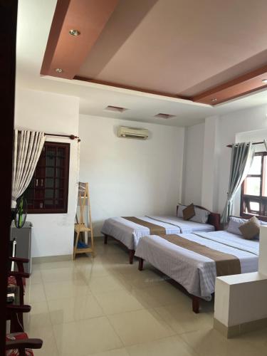 Ένα ή περισσότερα κρεβάτια σε δωμάτιο στο Hoàng Lai Hotel Mũi Né