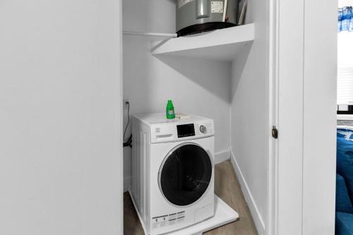 a washer and dryer in a corner of a room at Blue Bliss Indoor Pool, FREE Parking, Near NYC in Elizabeth