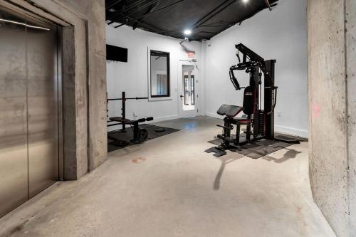 an empty room with a gym with two machines at Blue Bliss Indoor Pool, FREE Parking, Near NYC in Elizabeth