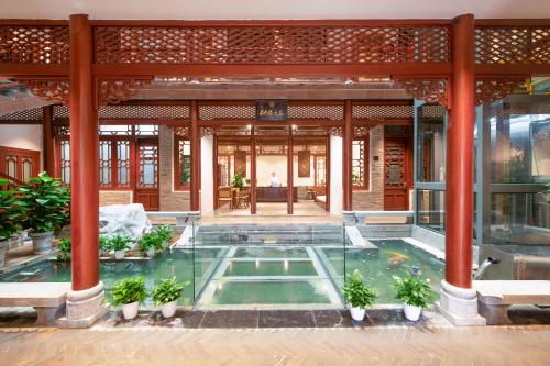 a pool in the middle of a building at Yangshuo Hidden Dragon Villa in Yangshuo