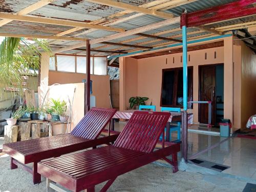 two red chairs sitting on a patio at MAMALIS HOMESTAY in Manado