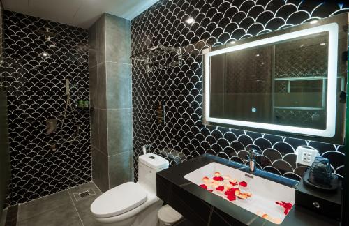 a bathroom with a toilet and a sink and a tub at Eden Hotel in Ho Chi Minh City
