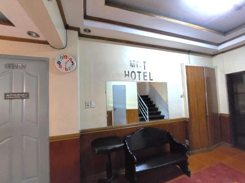 a waiting room with a chair and a mirror at MCT Hotel in Manila