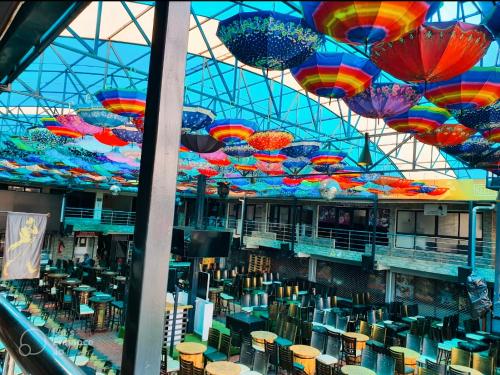 a building with colorful umbrellas hanging from the ceiling at The Hills View in Nairobi