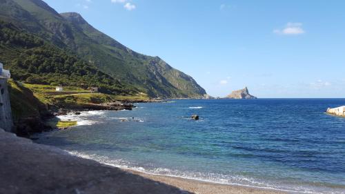 a view of a beach next to a mountain at Isoladelmiele in Marettimo