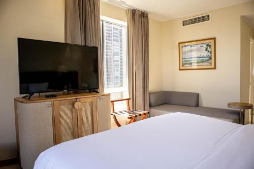 a bedroom with a bed and a flat screen tv at Hotel Caribe by Faranda Grand, a member of Radisson Individuals in Cartagena de Indias