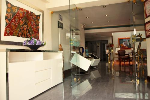 a living room with a white dresser and a table at Daniel's Apart Hotel in Lima