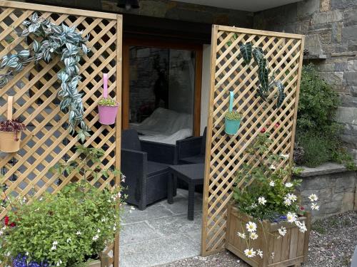 a pergola with potted plants in a garden at Chalet Douillet à Châtel - 5 Pers., 3 Ch. - FR-1-676-212 in Châtel