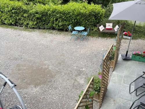 a patio with a table and chairs and an umbrella at Chalet Douillet à Châtel - 5 Pers., 3 Ch. - FR-1-676-212 in Châtel