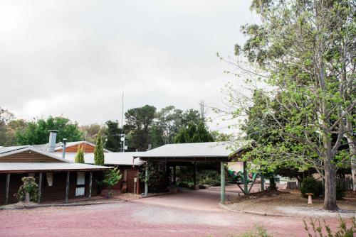 a group of houses with trees in the background at Granite Belt Retreat and Brewery in Stanthorpe