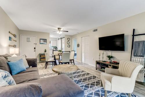 a living room with a couch and a tv at 3E Amelia Landings condo in Fernandina Beach
