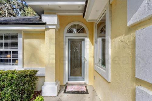 a yellow house with a door and a window at 4937 Windward Place home in Fernandina Beach