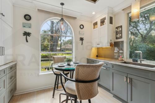 a kitchen with a table and chairs and a window at 4937 Windward Place home in Fernandina Beach