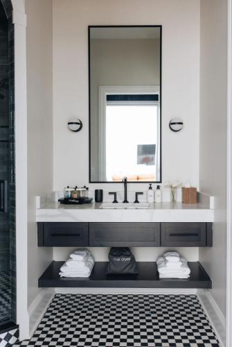 a bathroom with a sink and a mirror at The Purple Martin - Nest in Louisville