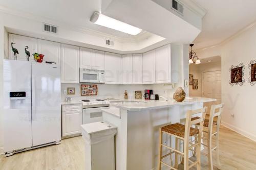 a white kitchen with white appliances and white cabinets at Ocean Place Condo in Amelia Island