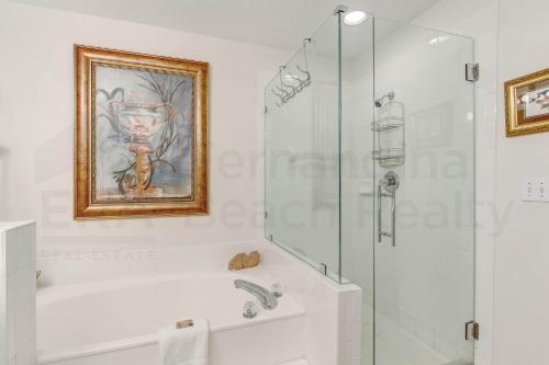 a white bathroom with a shower and a sink at Ocean Place Condo in Amelia Island