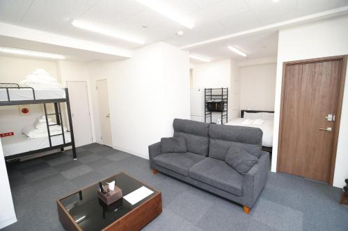 a living room with a couch and a bed at SOKOResort Hayama in Yokosuka