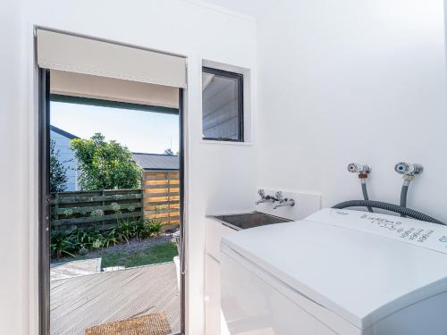 a bathroom with a sink and a mirror at Beaumont Beach Retreat - Pauanui Holiday Home in Pauanui