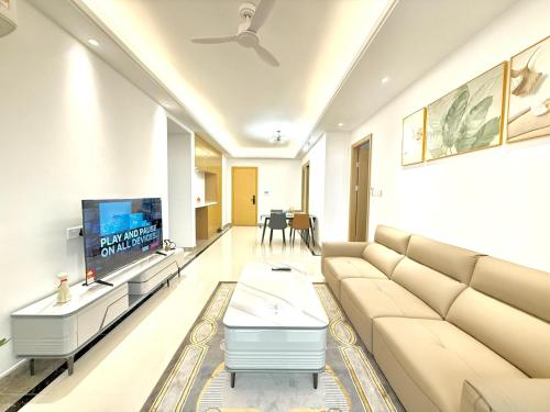a living room with a couch and a tv at R&F Seine Region in Johor Bahru