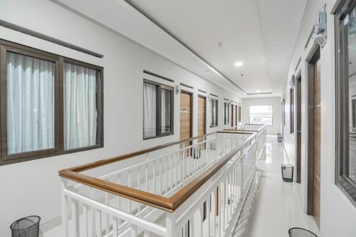 a hospital hallway with white walls and windows at RedDoorz Syariah @ Boemi Guesthouse Tasikmalaya in Tasikmalaya